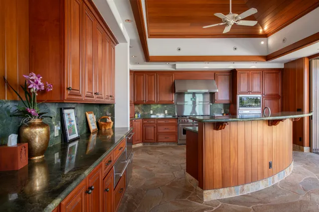 a kitchen with stainless steel appliances granite countertop a stove and cabinets