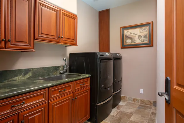 a kitchen with granite countertop stainless steel appliances a refrigerator and cabinets