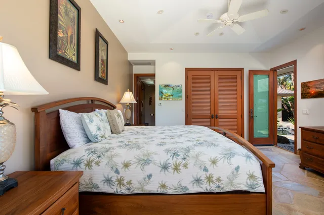 a bed sitting in a spacious bedroom next to a window