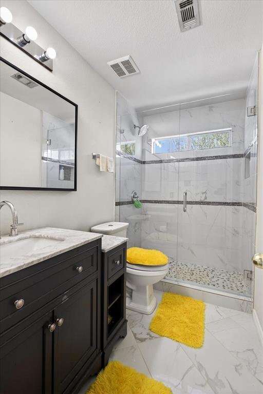 7308 Hawk Lane Sachse, TX 75048 - Photo 32 of 37 a bathroom with a sink mirror vanity and toilet