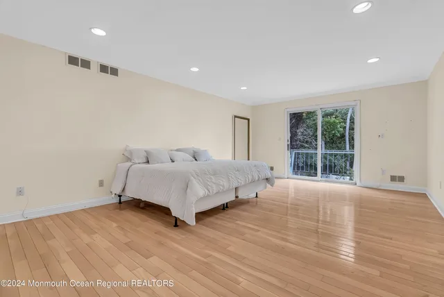a bathroom with a granite countertop sink a mirror and a shower