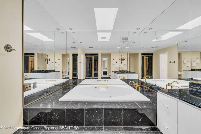 a large white kitchen with a large window