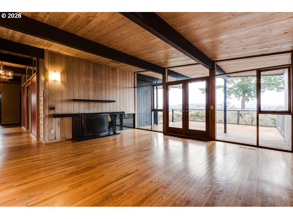2055 Broadview Street Eugene, OR 97405 - Photo 12 of 45 a view of empty room with wooden floor and fireplace