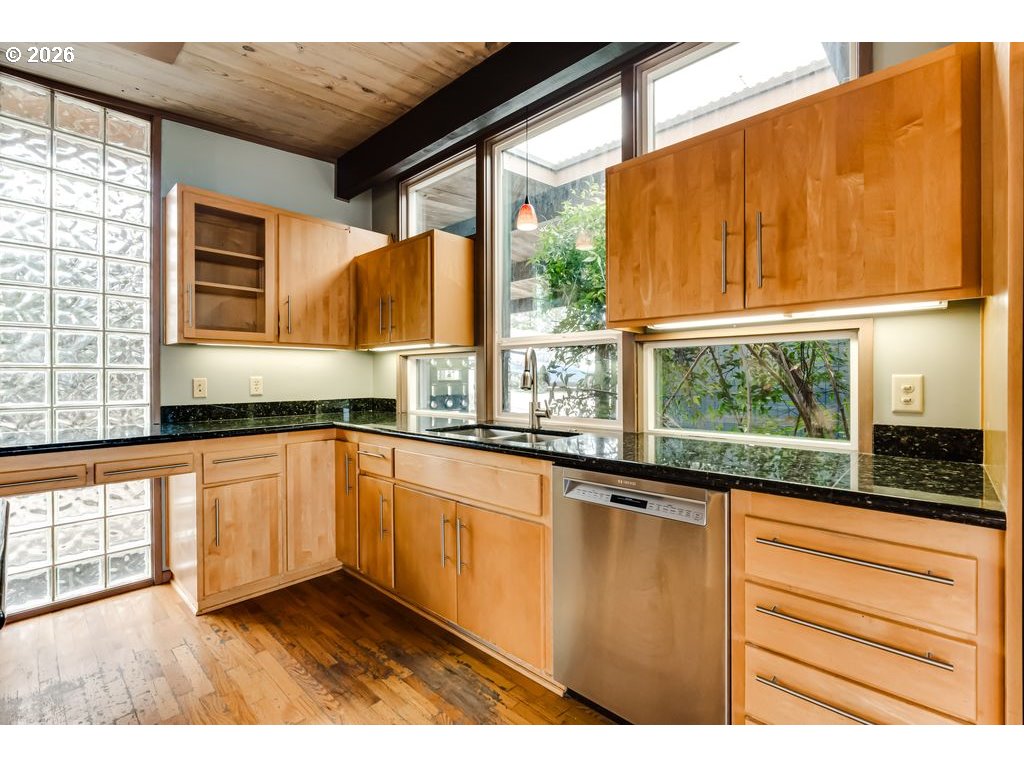 2055 Broadview Street Eugene, OR 97405 - Photo 15 of 45 a kitchen with granite countertop wooden cabinets a stove and a large window