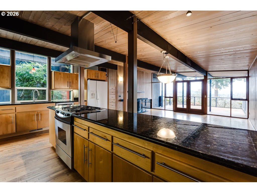 2055 Broadview Street Eugene, OR 97405 - Photo 19 of 45 a kitchen with stainless steel appliances granite countertop a sink a stove and a wooden floors