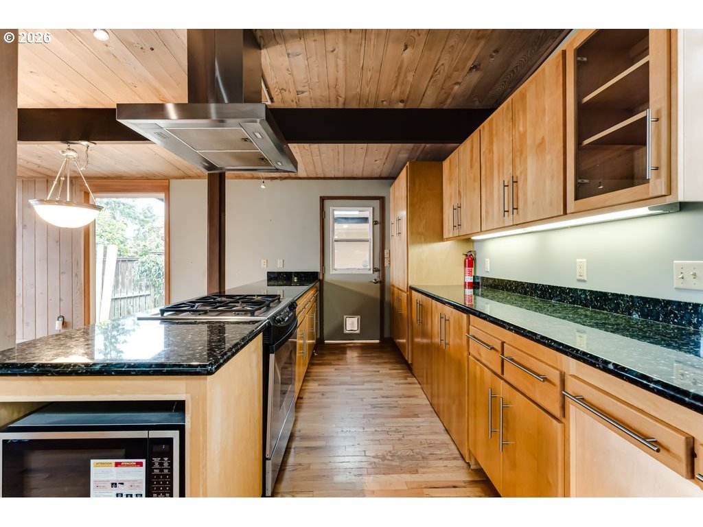 2055 Broadview Street Eugene, OR 97405 - Photo 20 of 45 a kitchen with stainless steel appliances granite countertop a stove a sink and a microwave