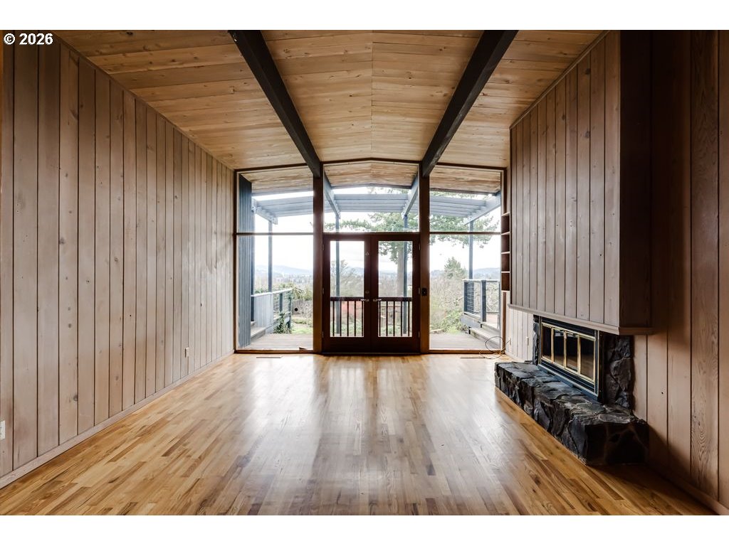 2055 Broadview Street Eugene, OR 97405 - Photo 6 of 45 a view of an empty room with wooden floor and a window