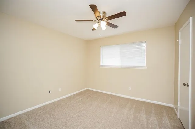a bath tub sitting next to a white toilet and a shower