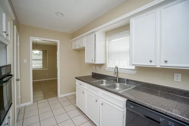 a kitchen with stainless steel appliances granite countertop a sink and a stove
