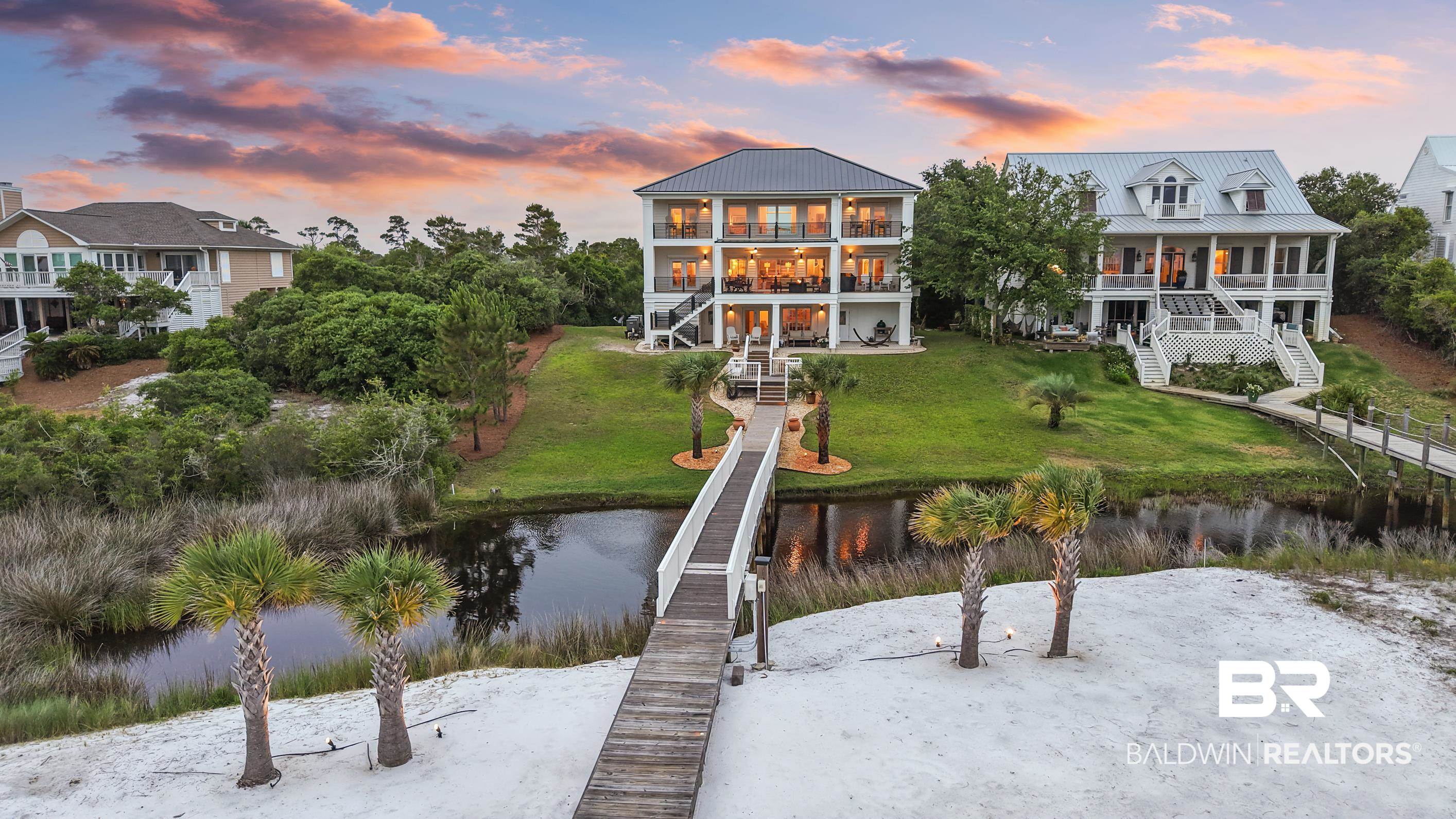 30954 River Road Orange Beach, AL 36561 - Photo 5 of 59 Back of property featuring stairway, a water view, a yard, and metal roof