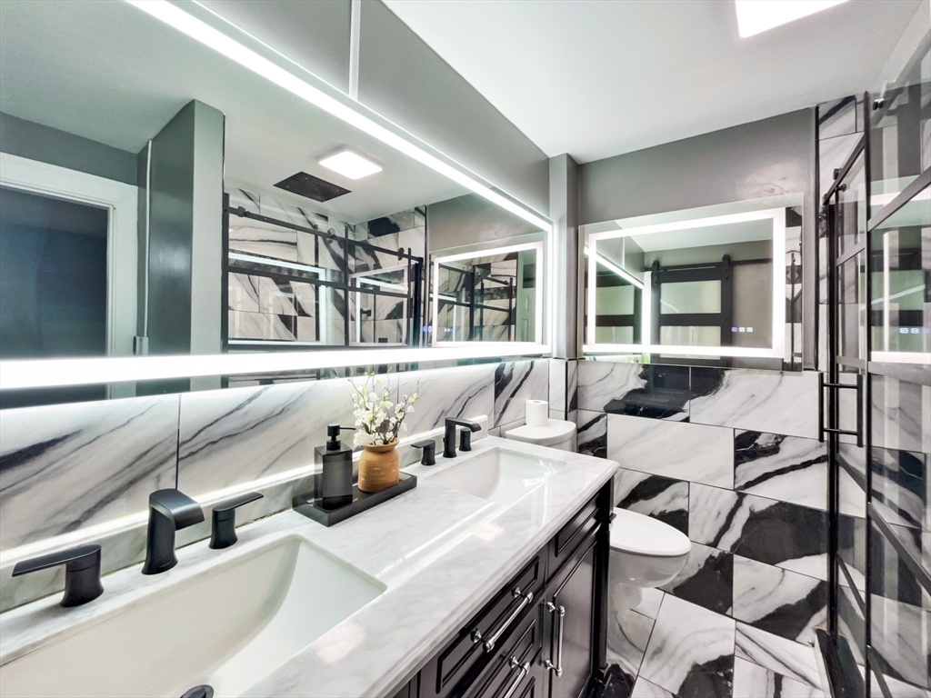 140 Chestnut Street, Unit 706 Springfield, MA 01103 - Photo 11 of 23 a kitchen with a sink dishwasher and a refrigerator with a large mirror