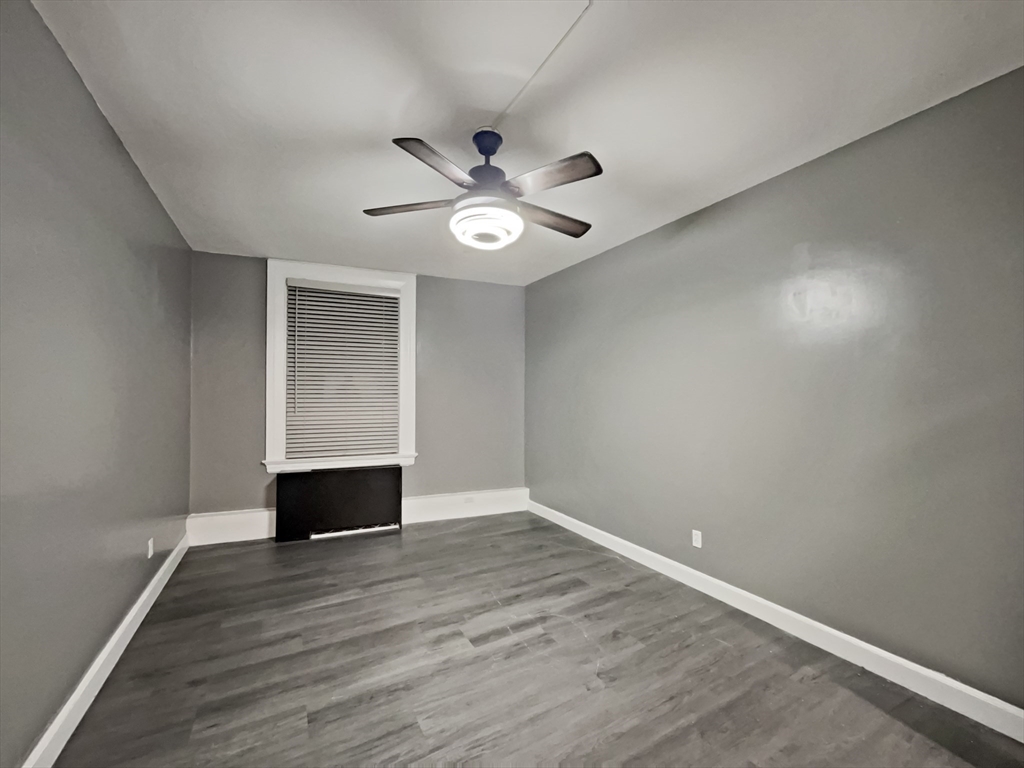 140 Chestnut Street, Unit 706 Springfield, MA 01103 - Photo 14 of 23 wooden floor in an empty room with a window