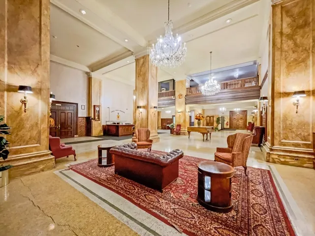 a living room with patio furniture and a chandelier