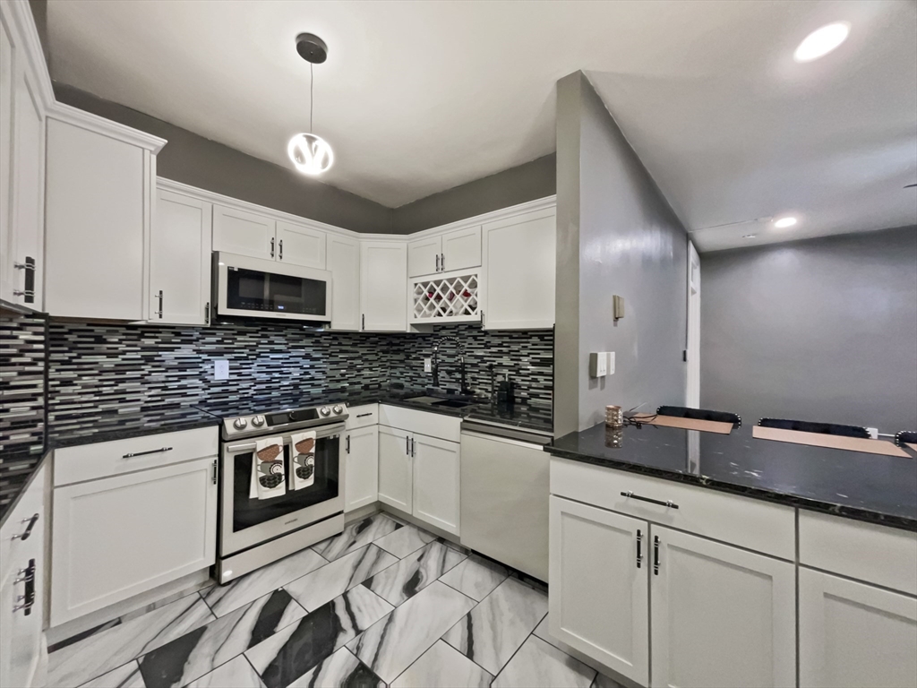 140 Chestnut Street, Unit 706 Springfield, MA 01103 - Photo 3 of 23 a kitchen with stainless steel appliances granite countertop a sink and cabinets