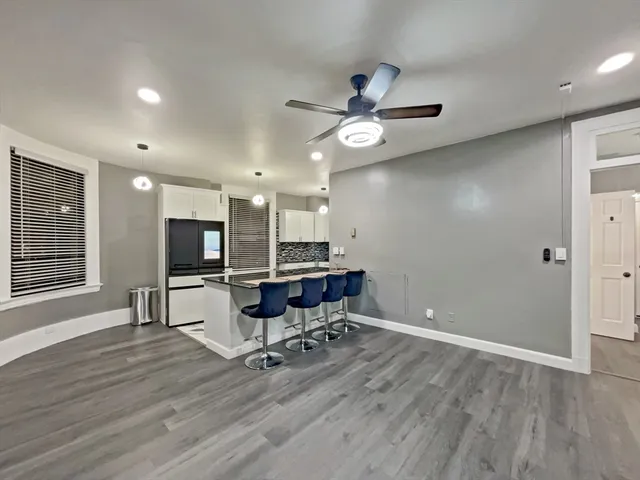 a view of a workspace with furniture and a kitchen