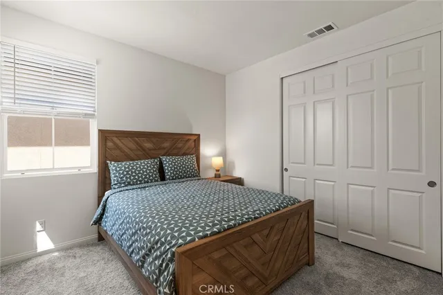 a bedroom with a bed and window