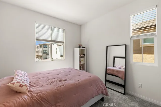 a bedroom with a bed and a window with outer view