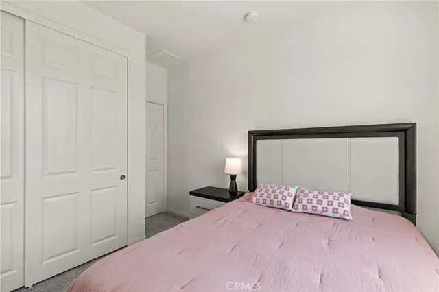 a bedroom with a bed and a mirror