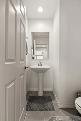 a bathroom with a sink a toilet and mirror