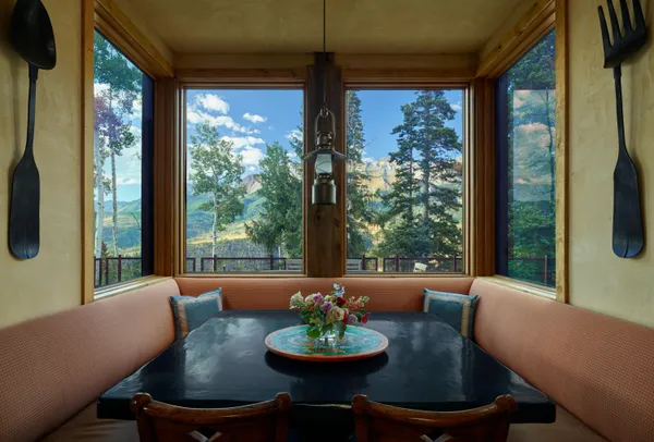 a view of a dining room with furniture wooden floor and a chandelier