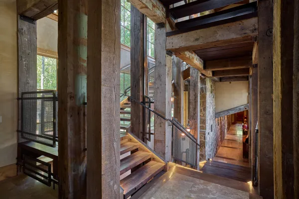a view of a hallway with a door and stairs