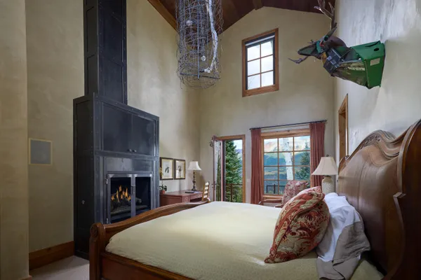 a bed sitting in a bedroom next to a window