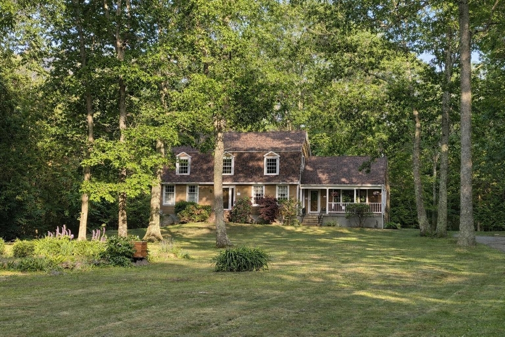 75 Barre Road Hubbardston, MA 01452 - Photo 2 of 42 a front view of a house with a garden and trees