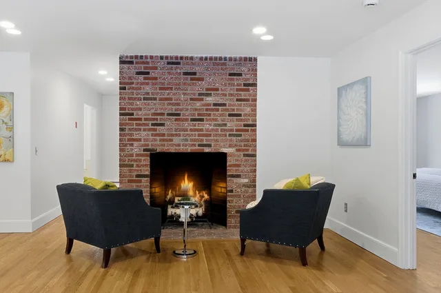 a view of a livingroom with furniture and a fireplace
