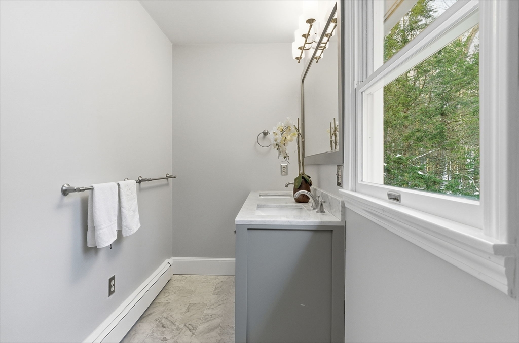75 Barre Road Hubbardston, MA 01452 - Photo 30 of 42 a bathroom with a sink a mirror and window