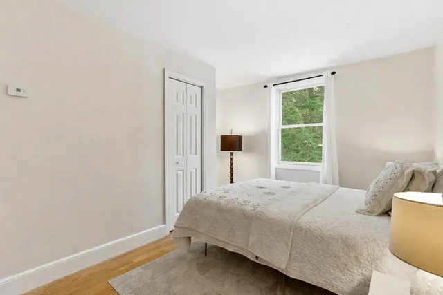 a bedroom with a bed and a lamp