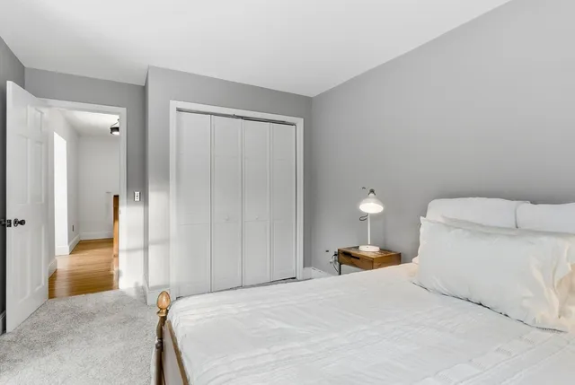 a bathroom with a granite countertop toilet sink and mirror