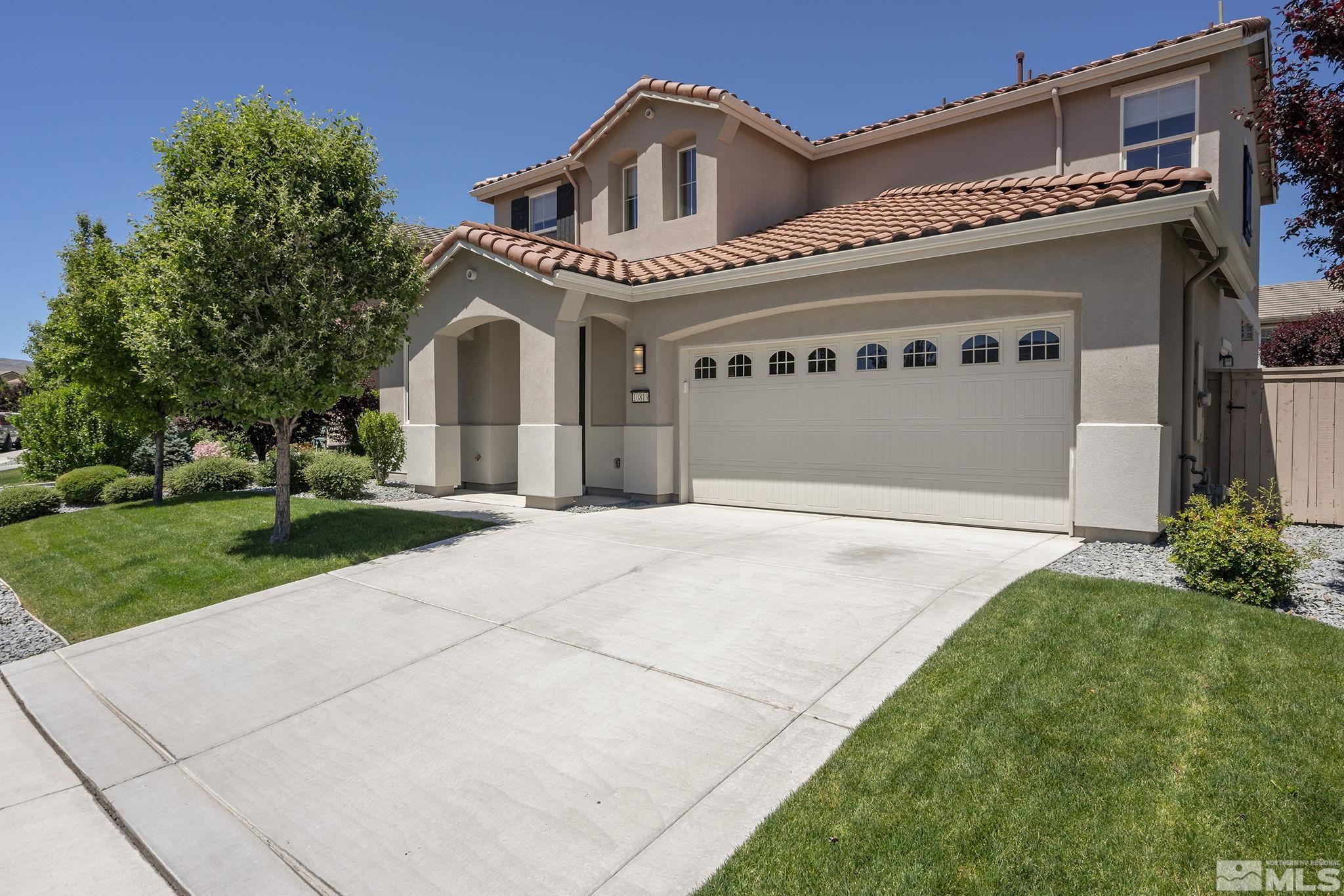 a front view of a house with a yard and garage