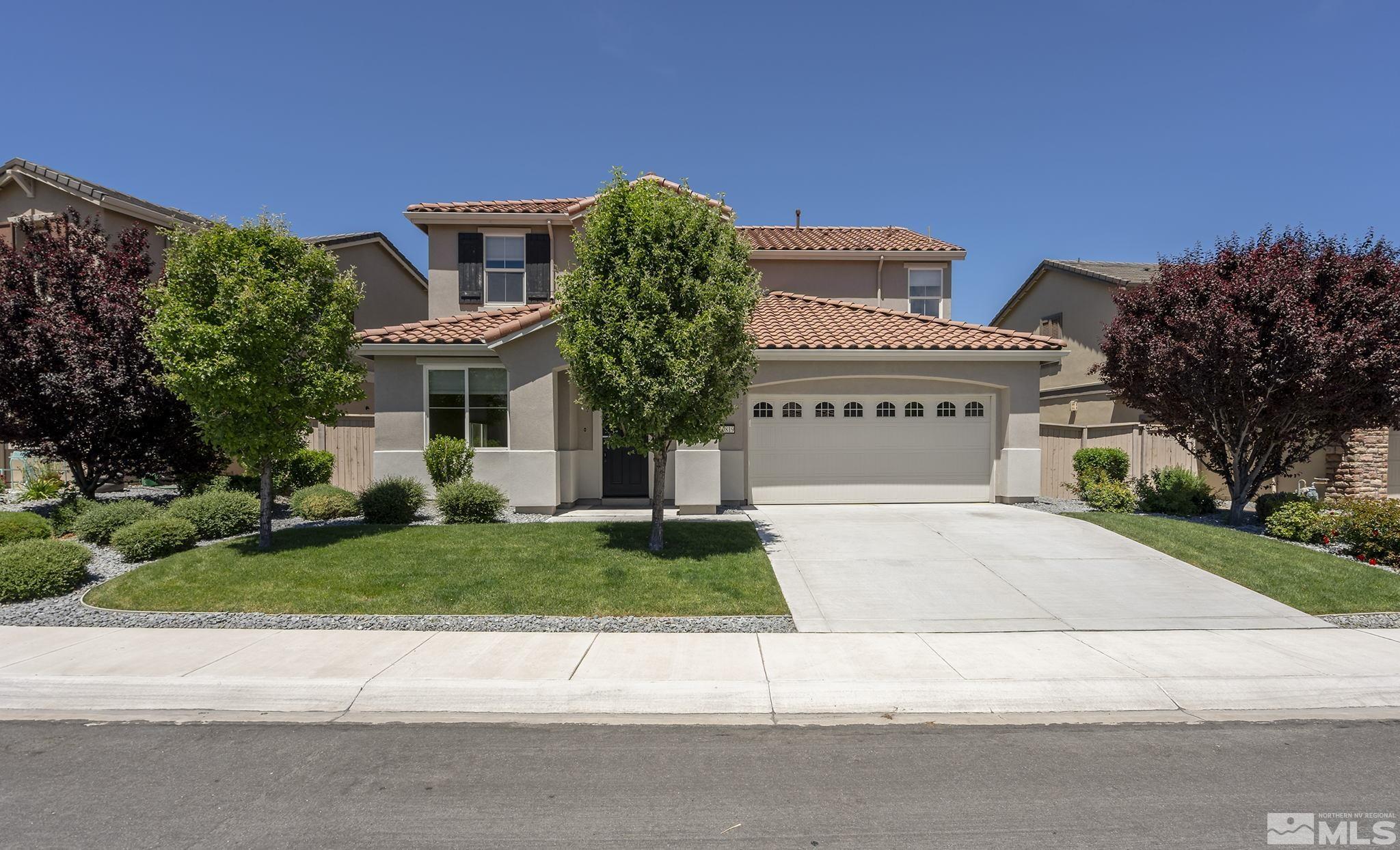 10819 Walnut Ridge Drive Reno, NV 89521 - Photo 20 of 22 a front view of a house with a garden and garage