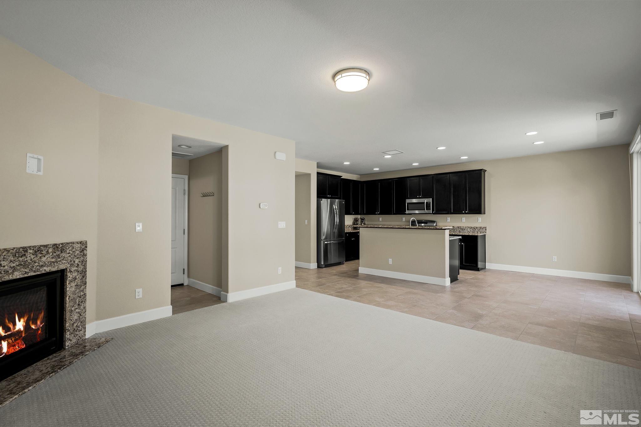 10819 Walnut Ridge Drive Reno, NV 89521 - Photo 6 of 22 a view of a kitchen with a sink and a fireplace