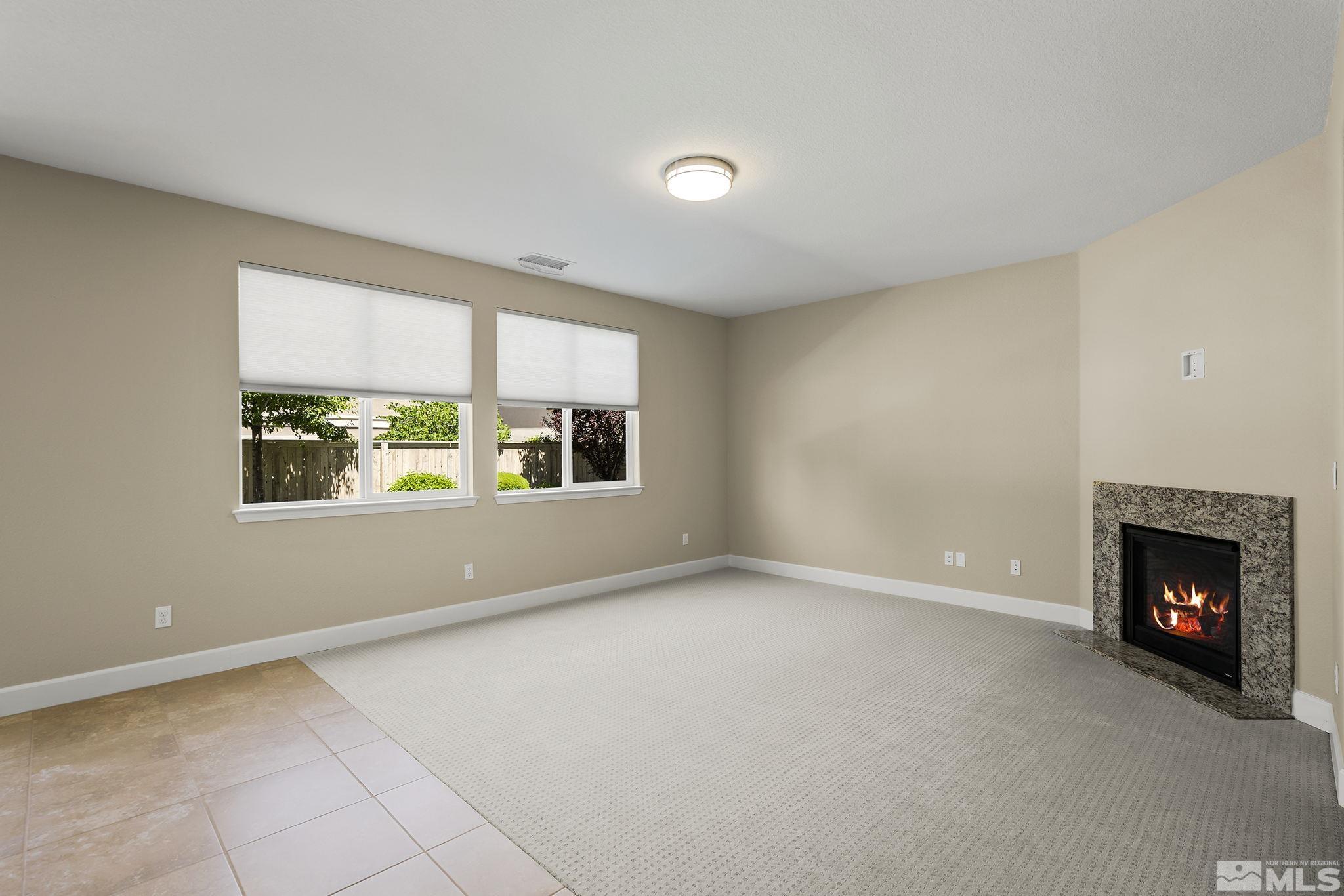 10819 Walnut Ridge Drive Reno, NV 89521 - Photo 7 of 22 a view of an empty room with a window and fireplace