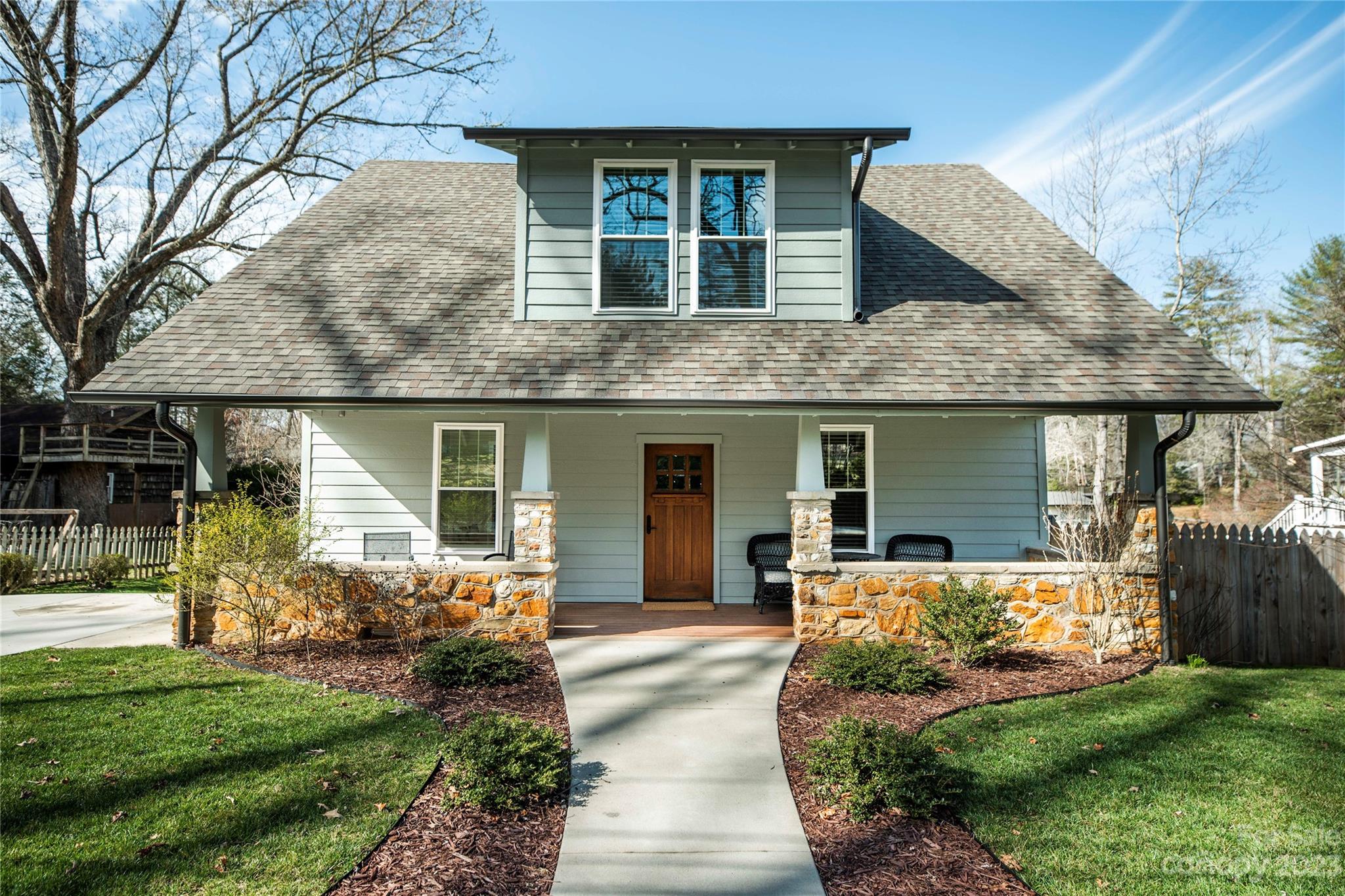 a front view of a house with a yard and porch