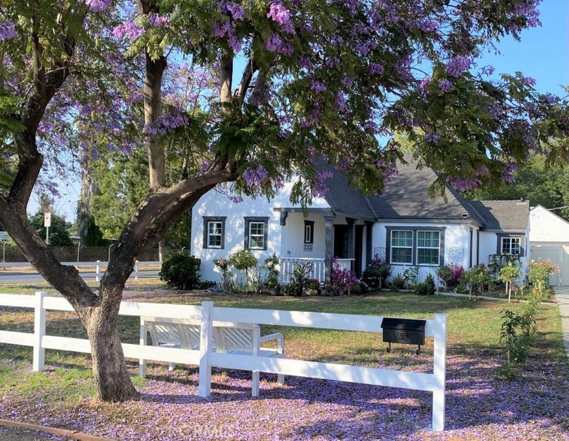 3493 Hoover Street Riverside, CA 92506 - Photo 1 of 1 a front view of a house with a garden and trees