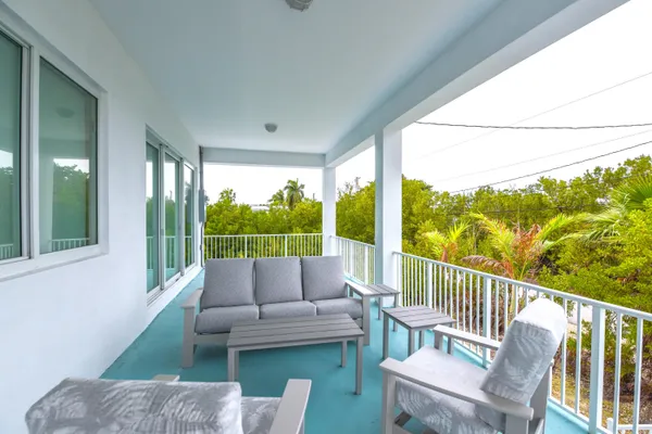 a view of a backyard with plants and a patio