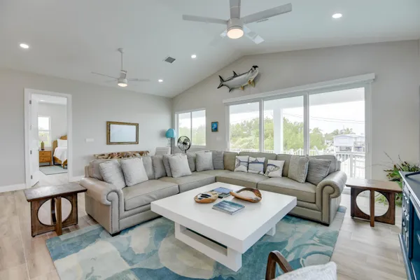 a living room with furniture a window and a flat screen tv