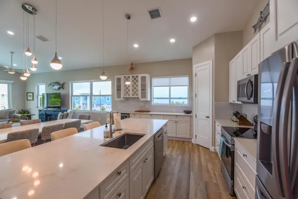 a kitchen with stainless steel appliances kitchen island granite countertop a sink and cabinets