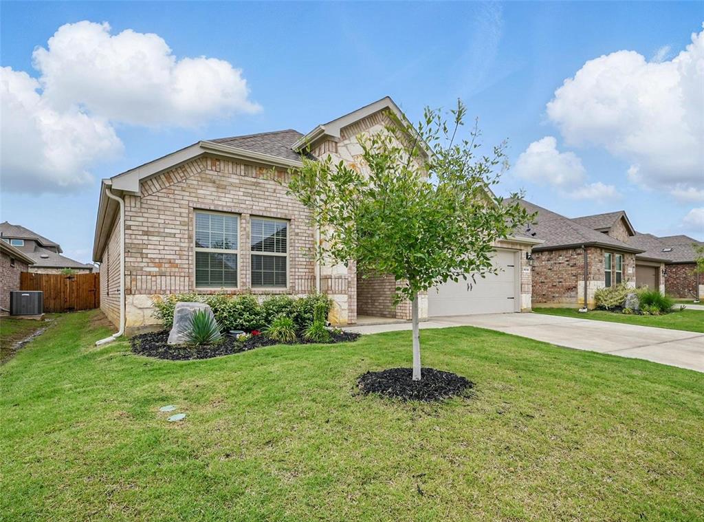 a front view of a house with a yard and garage
