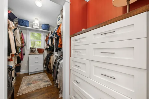 a view of walk in closet with clothes
