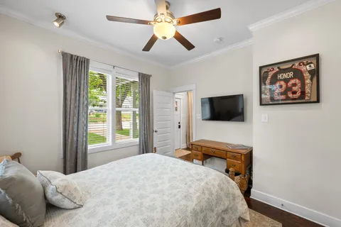 a bedroom with a bed and a flat screen tv