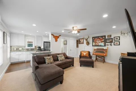 a living room with furniture and a view of kitchen