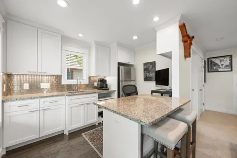 a kitchen with a stove a sink and a refrigerator