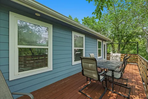 a view of backyard with a deck and wooden floor