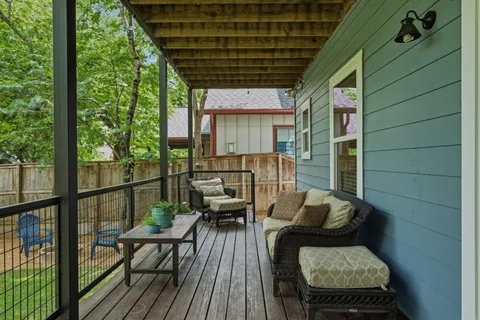 a balcony with furniture and wooden floor