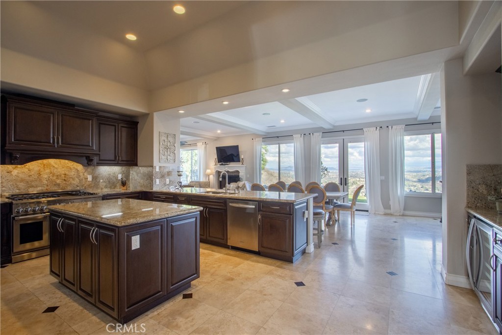 44195 Vía Horca Temecula, CA 92590 - Photo 14 of 74 a kitchen with stainless steel appliances granite countertop lots of counter top and stove