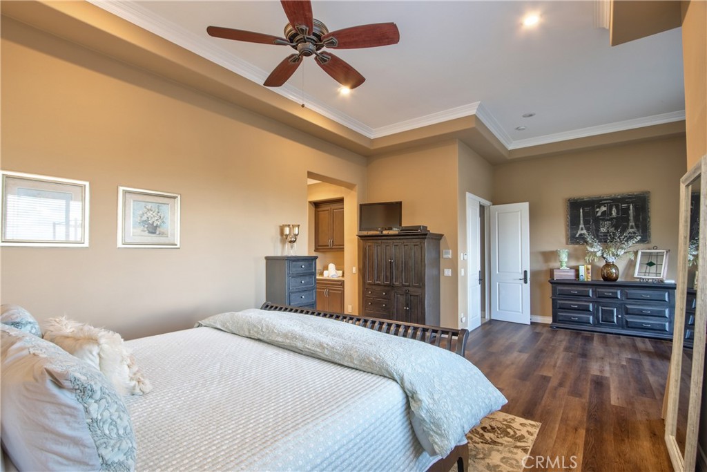 44195 Vía Horca Temecula, CA 92590 - Photo 24 of 74 a bedroom with a bed and a chandelier