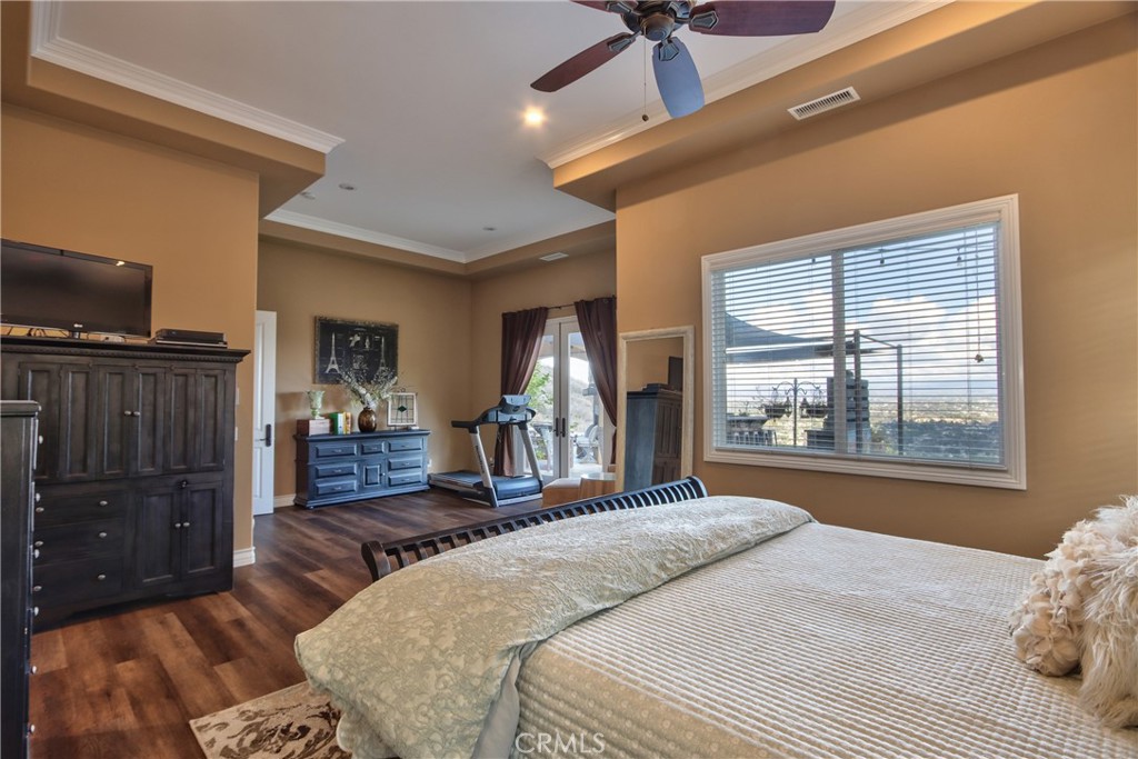 44195 Vía Horca Temecula, CA 92590 - Photo 25 of 74 a bedroom with a bed and wooden floor